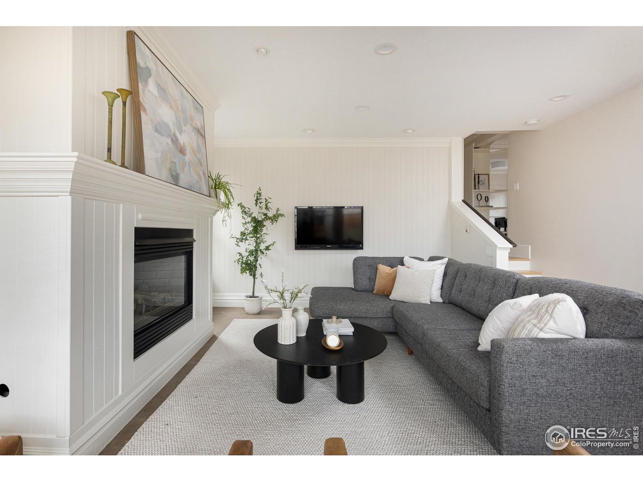 721 Concord Avenue Boulder, CO 80304 - Photo 8 of 40 a living room with furniture a flat screen tv and a fireplace