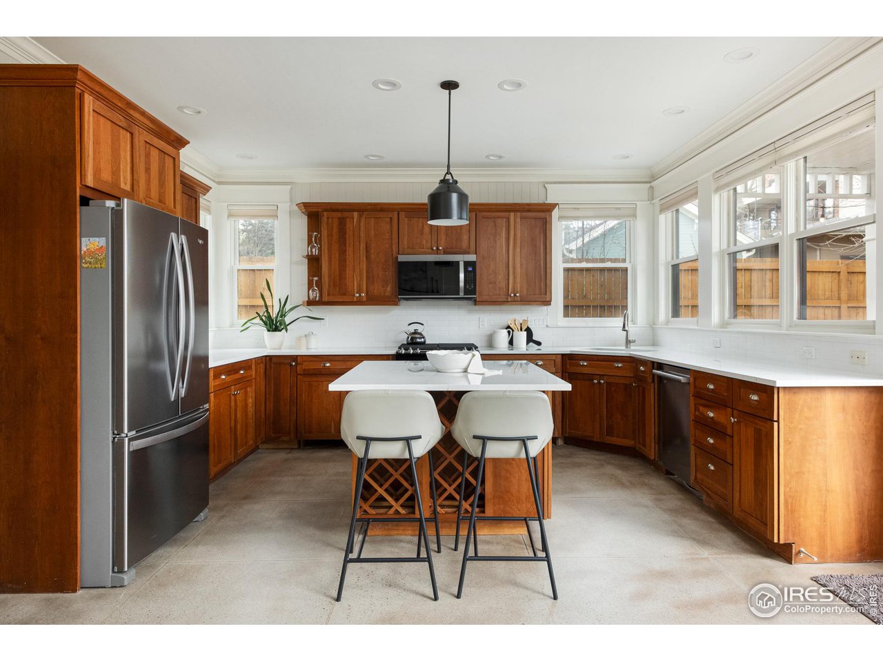 721 Concord Avenue Boulder, CO 80304 - Photo 9 of 40 a kitchen with stainless steel appliances granite countertop a refrigerator a sink dishwasher a stove a dining table and chairs with wooden floor