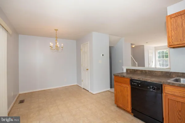 a kitchen with a stove and chandelier