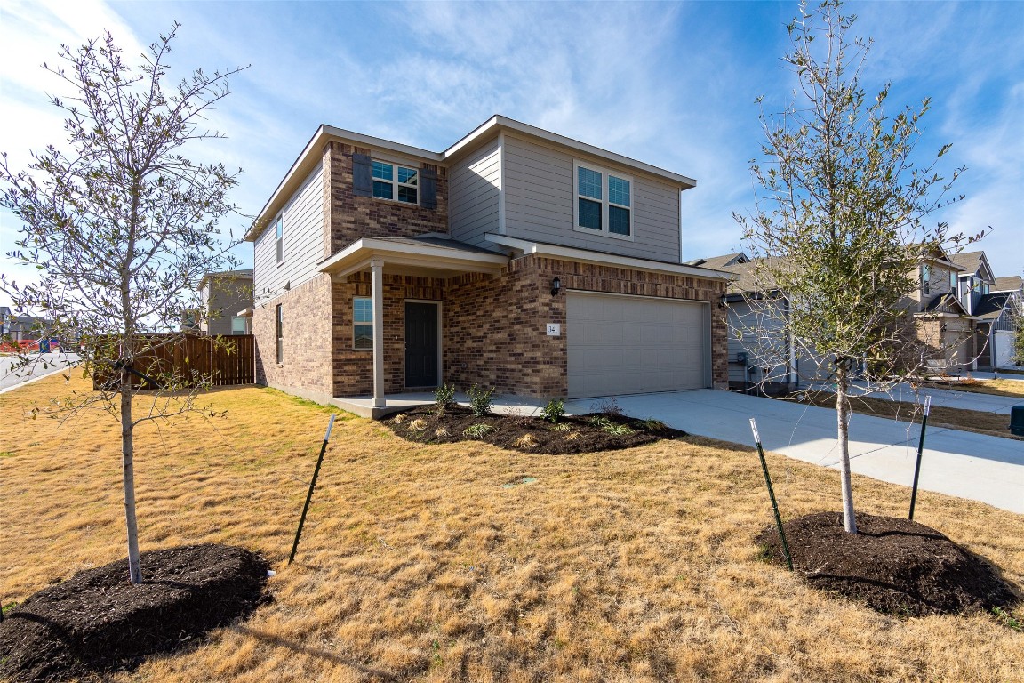 a front view of a house with a yard