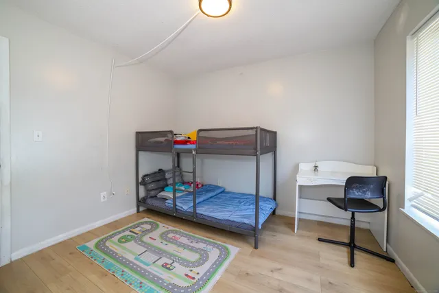 a bedroom with furniture and a window