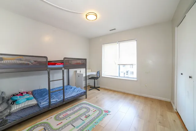 a bedroom with furniture and a window