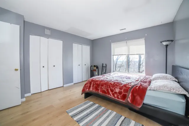 a bedroom with a bed and a window