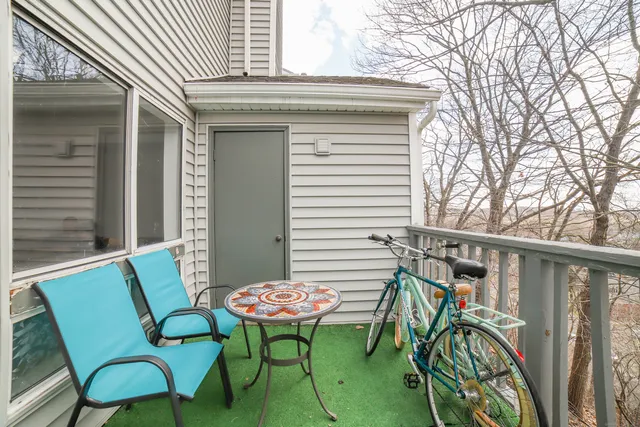 a view of a chairs and table in the balcony