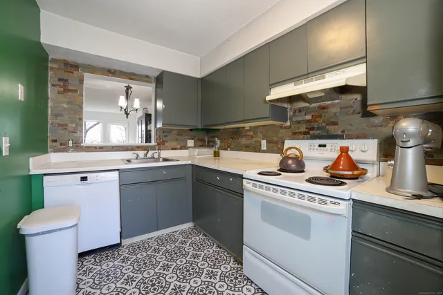 a kitchen with a sink stove and cabinets