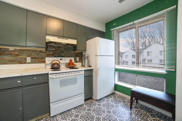 a kitchen with a refrigerator and a sink
