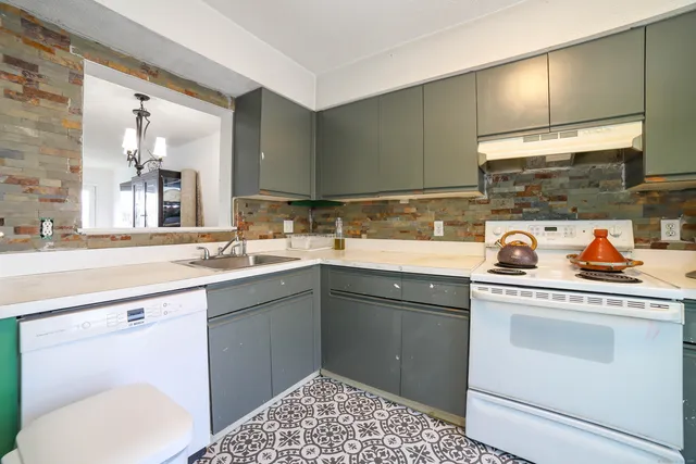 a kitchen with a sink cabinets and appliances