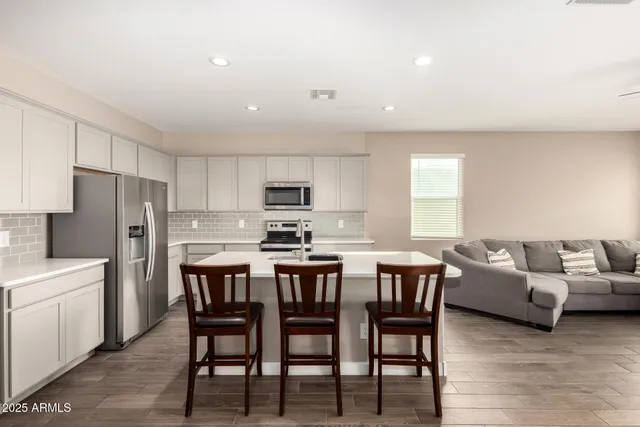 a large kitchen with a table and chairs
