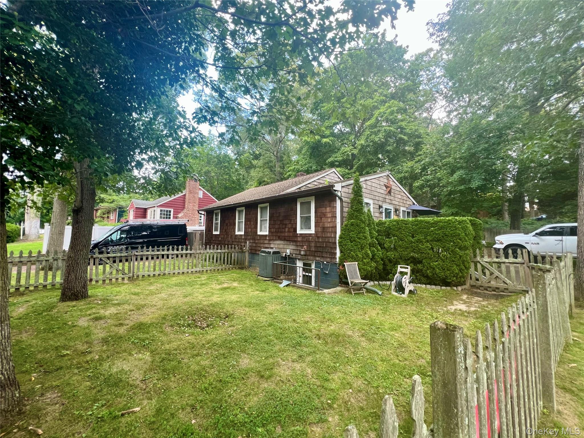 230 Lakeside Trail Ridge, NY 11961 - Photo 2 of 33 a view of house with backyard and seating area