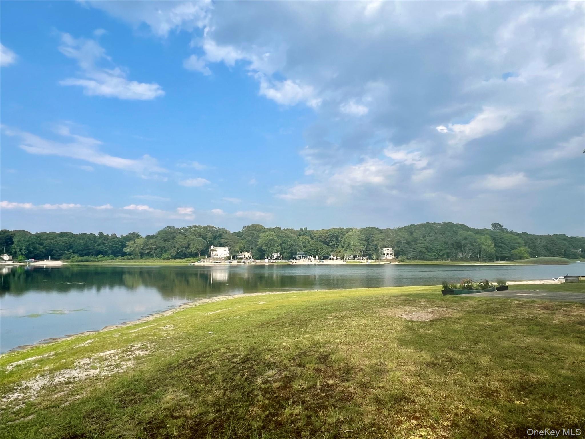 230 Lakeside Trail Ridge, NY 11961 - Photo 24 of 33 a view of a lake with houses in the back