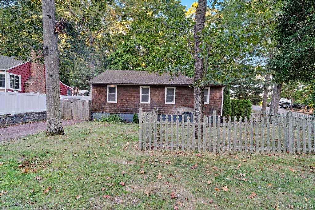 230 Lakeside Trail Ridge, NY 11961 - Photo 27 of 33 a front view of a house with a yard