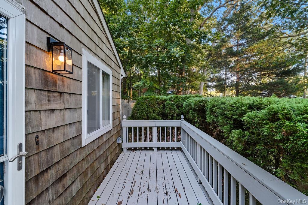 230 Lakeside Trail Ridge, NY 11961 - Photo 6 of 33 a view of balcony with wooden floor and fence and a potted plant