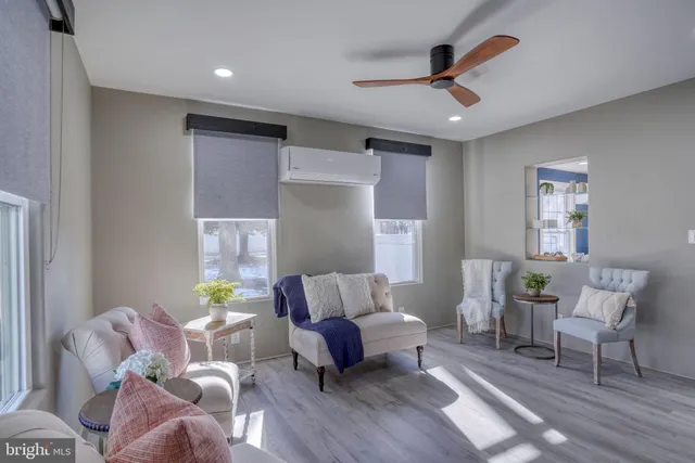 a kitchen with stainless steel appliances granite countertop a sink dishwasher and a refrigerator with wooden floor