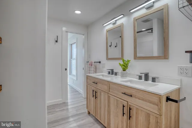 a bathroom with a sink toilet and mirror