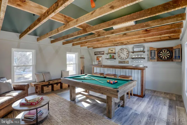 a view of backyard with large trees and wooden fence