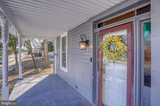 a view of entryway with paintings on the wall