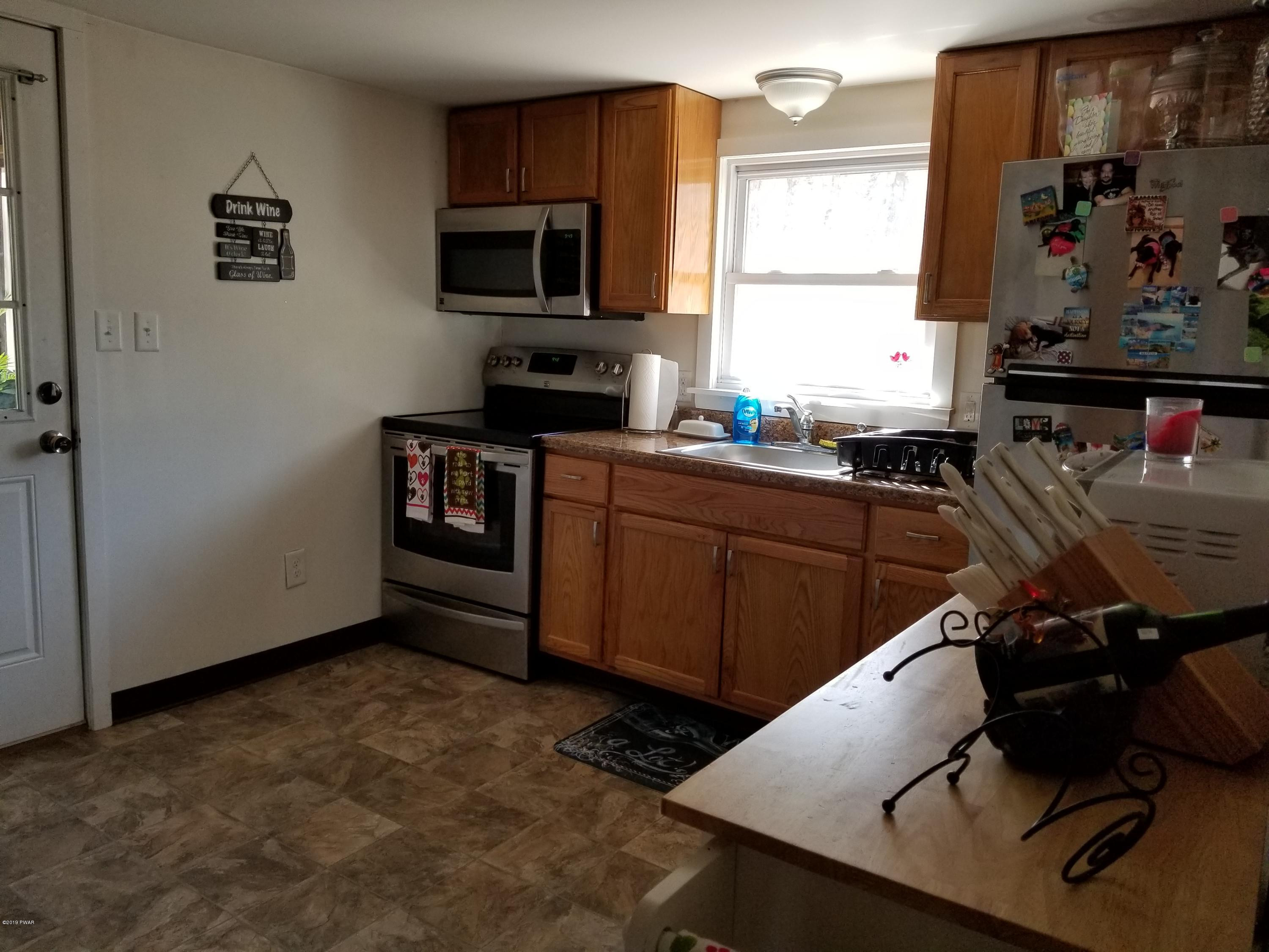 108 Red Pine Road Dingmans Ferry, PA 18328 - Photo 7 of 15 a kitchen with a sink appliances and cabinets