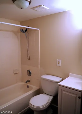 a white toilet sitting next to a bath tub