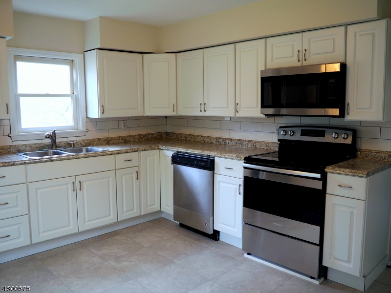 41 Canal Street Landing, NJ 07850 - Photo 4 of 20 a kitchen with white cabinets and stainless steel appliances