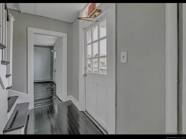 a view of a hallway and wooden floor