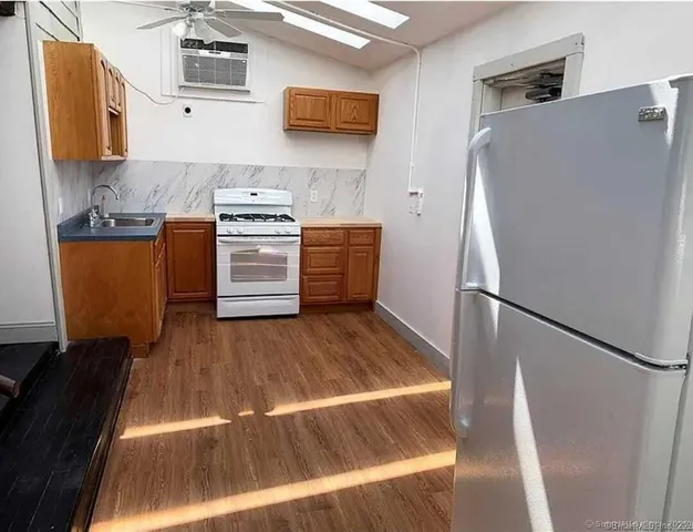 a kitchen with a refrigerator and a stove