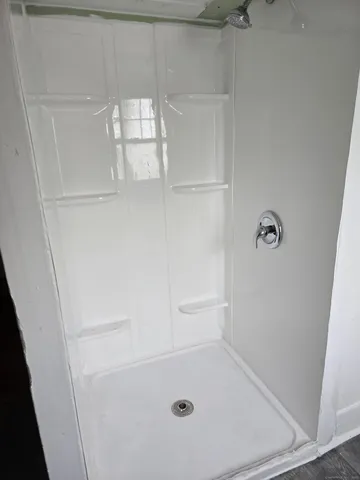 a bathroom with a glass shower door