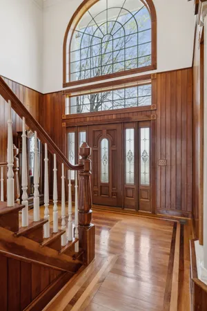 a view of an entryway with wooden floor