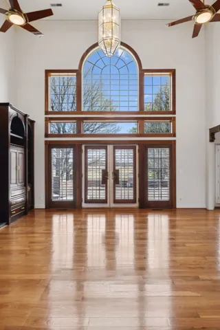 a bedroom with a bed and a dresser next to a window