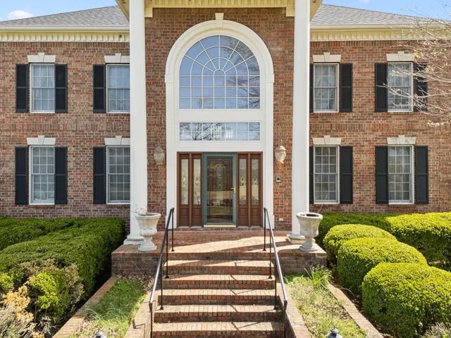 a view of a white house with a large pool and a yard