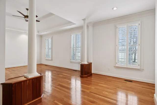 a living room with fireplace furniture and a wooden floor