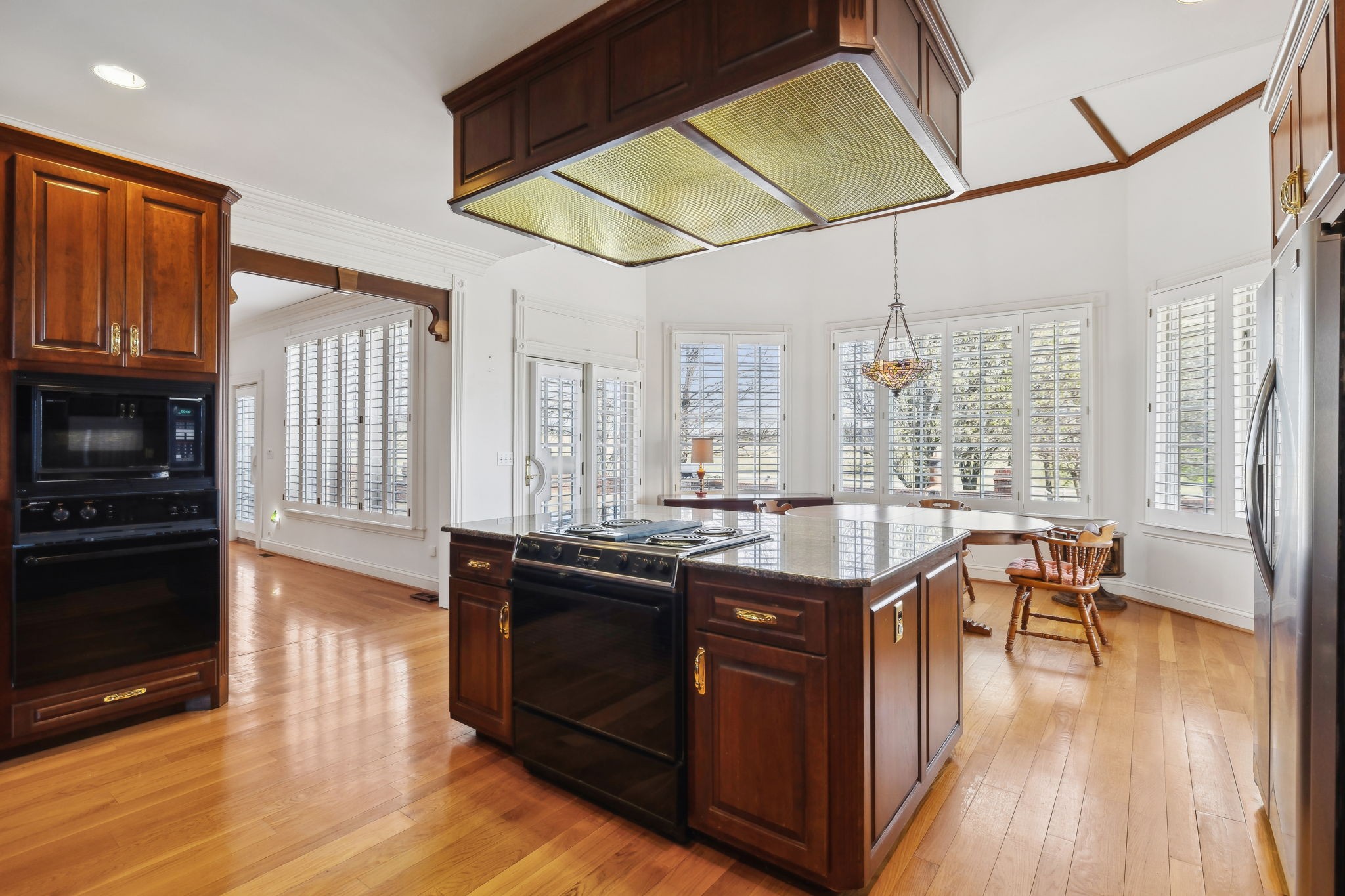 5090 Main Street Spring Hill, TN 37174 - Photo 58 of 91 a kitchen with a table chairs stove and cabinets