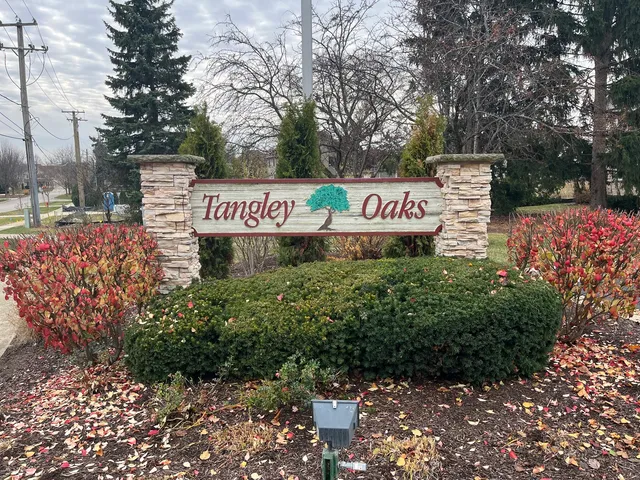 a sign that is sitting in front of flowers