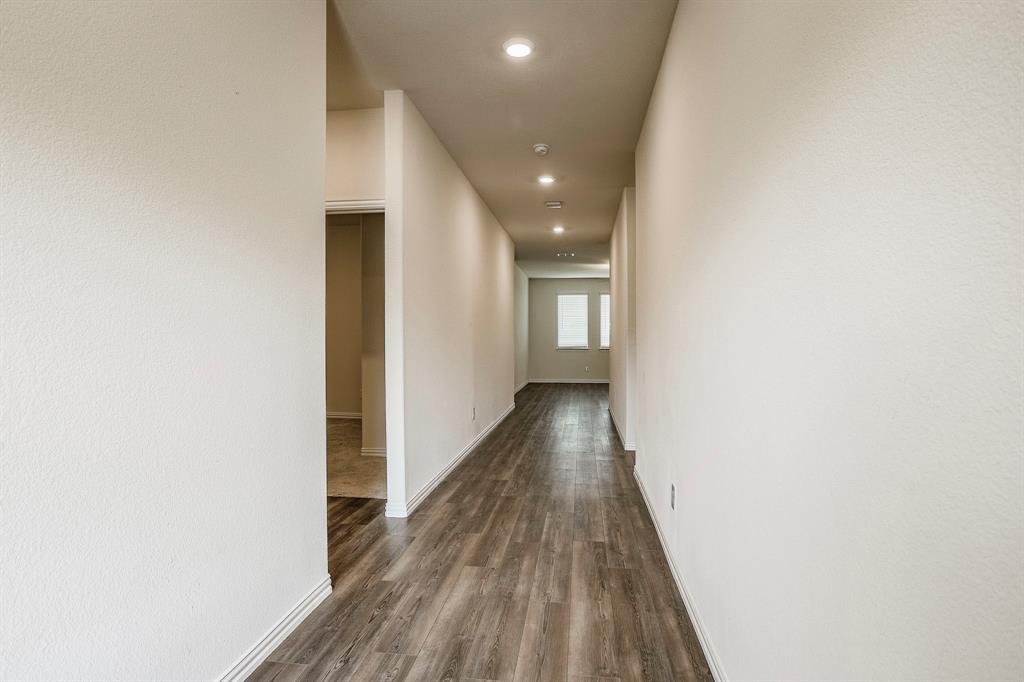 652 Ridgeback Trail Fort Worth, TX 76052 - Photo 4 of 20 Hallway with dark hardwood / wood-style floors