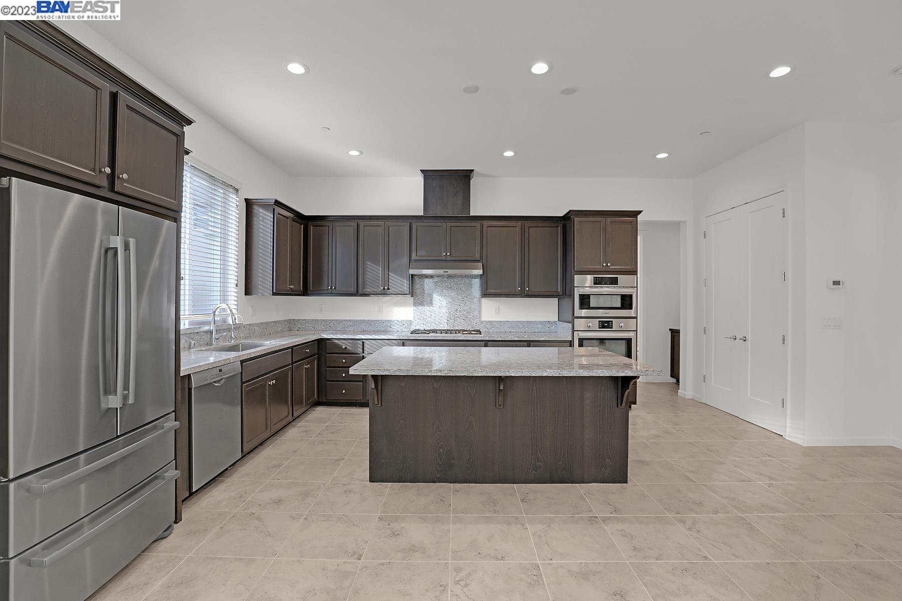 5772 Barley Road Dublin, CA 94568 - Photo 11 of 56 a kitchen with stainless steel appliances granite countertop a refrigerator and a stove