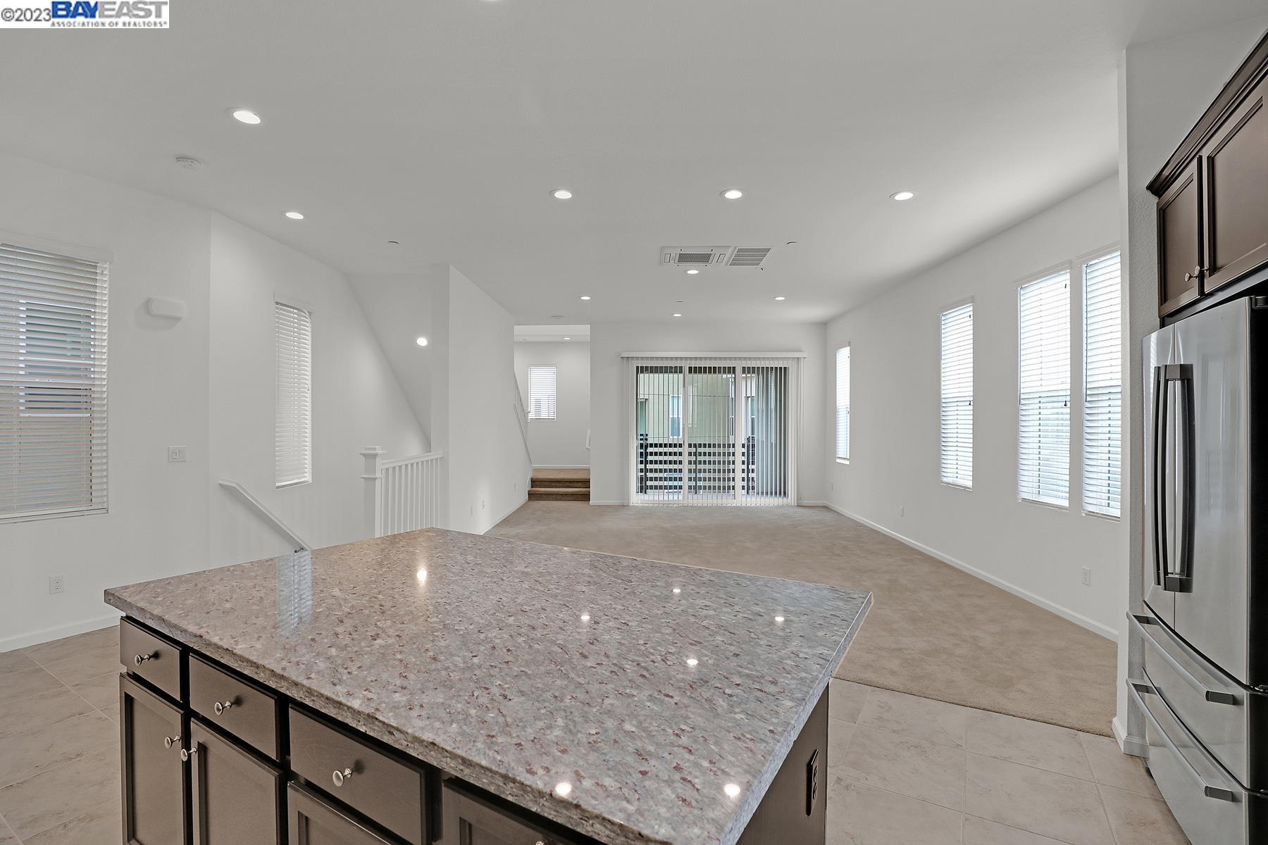 5772 Barley Road Dublin, CA 94568 - Photo 14 of 56 a view of a kitchen with granite countertop a center island and a refrigerator