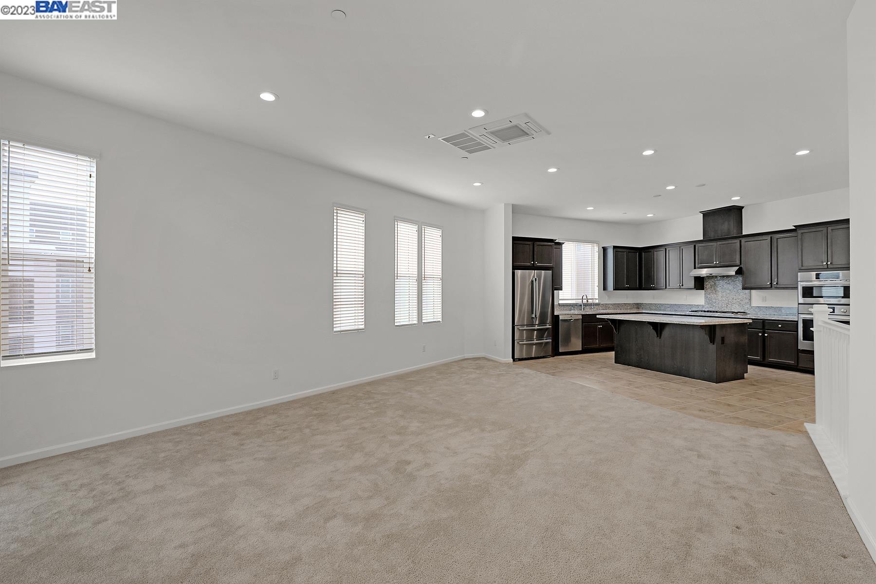 5772 Barley Road Dublin, CA 94568 - Photo 17 of 56 a large white kitchen with kitchen island a sink a stove and a refrigerator