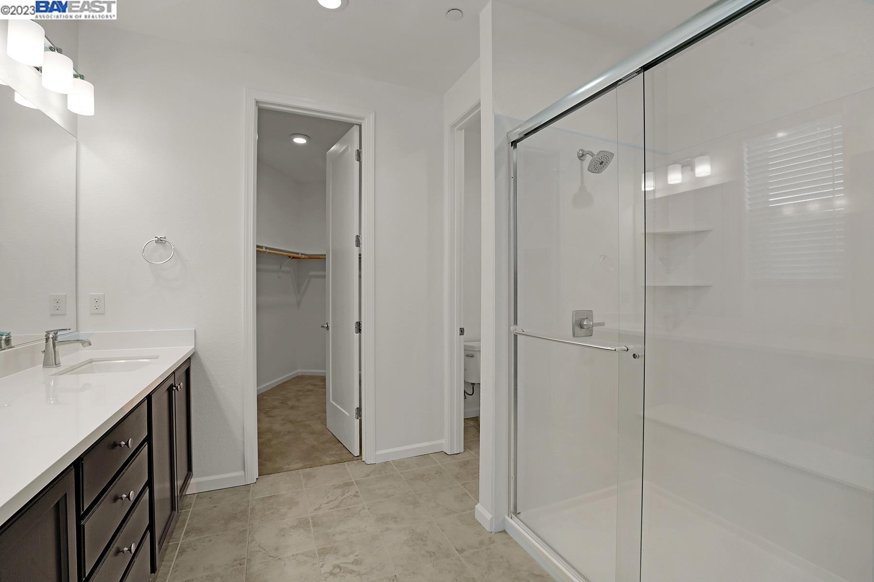 5772 Barley Road Dublin, CA 94568 - Photo 27 of 56 a bathroom with a double vanity sink mirror and shower