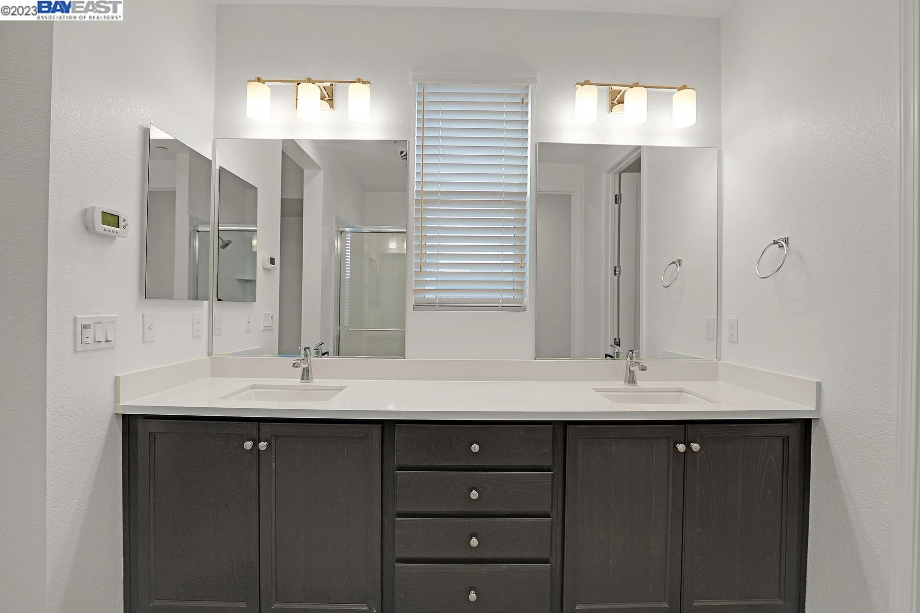 5772 Barley Road Dublin, CA 94568 - Photo 28 of 56 a bathroom with a granite countertop sink and a mirror