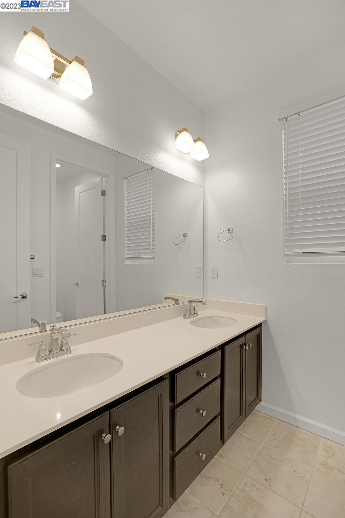 5772 Barley Road Dublin, CA 94568 - Photo 35 of 56 a bathroom with a sink double vanity granite and a mirror