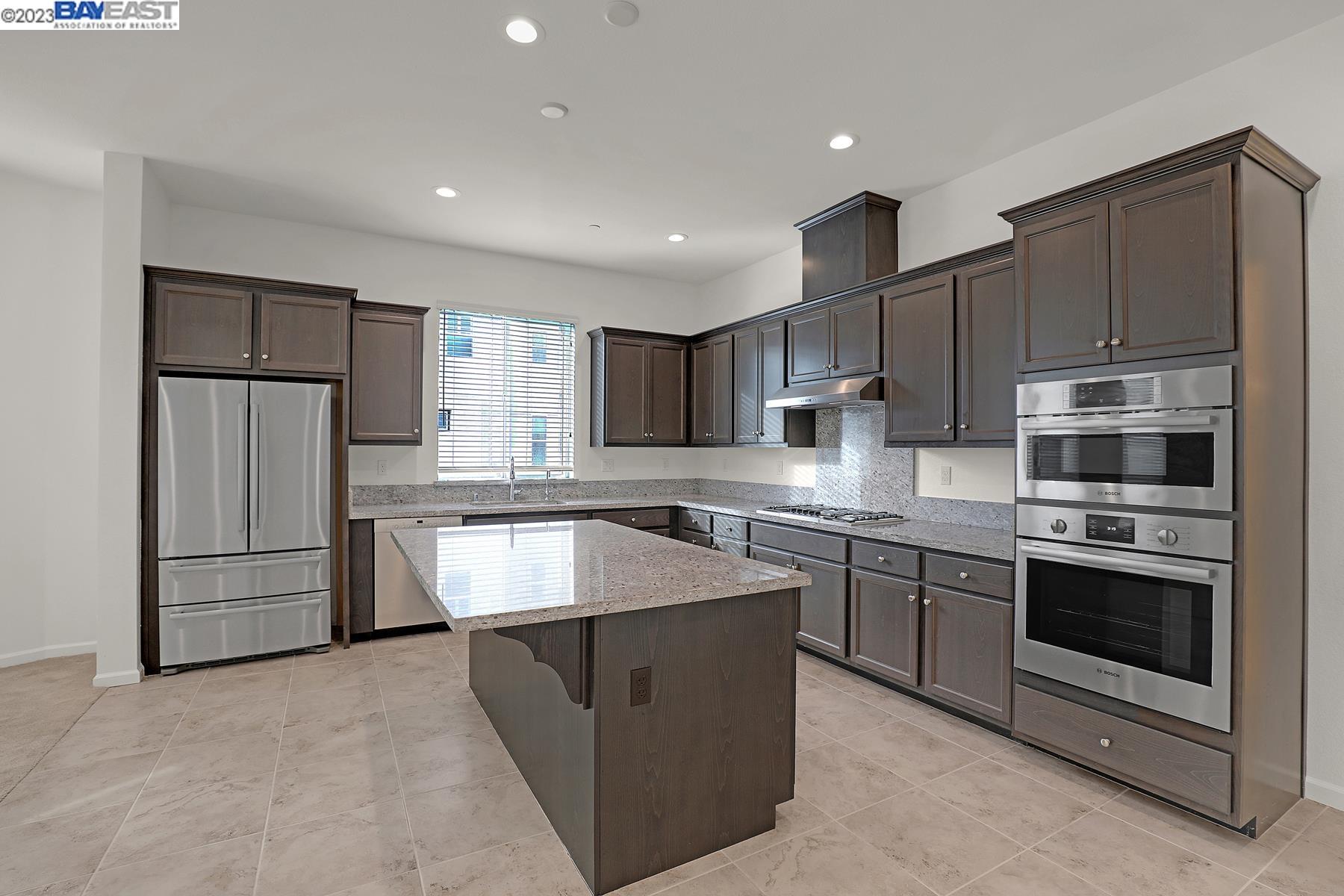 5772 Barley Road Dublin, CA 94568 - Photo 10 of 56 a kitchen with stainless steel appliances granite countertop a stove a sink dishwasher a refrigerator and a oven with wooden floor