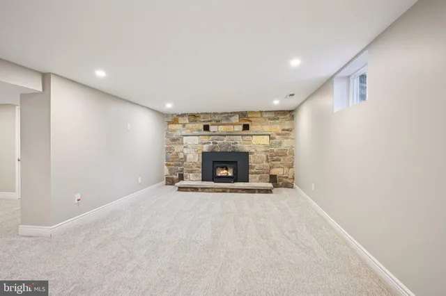 a view of an empty room with a fireplace