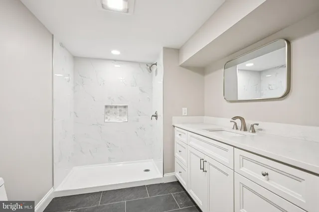 a bathroom with a double vanity sink mirror and bathtub