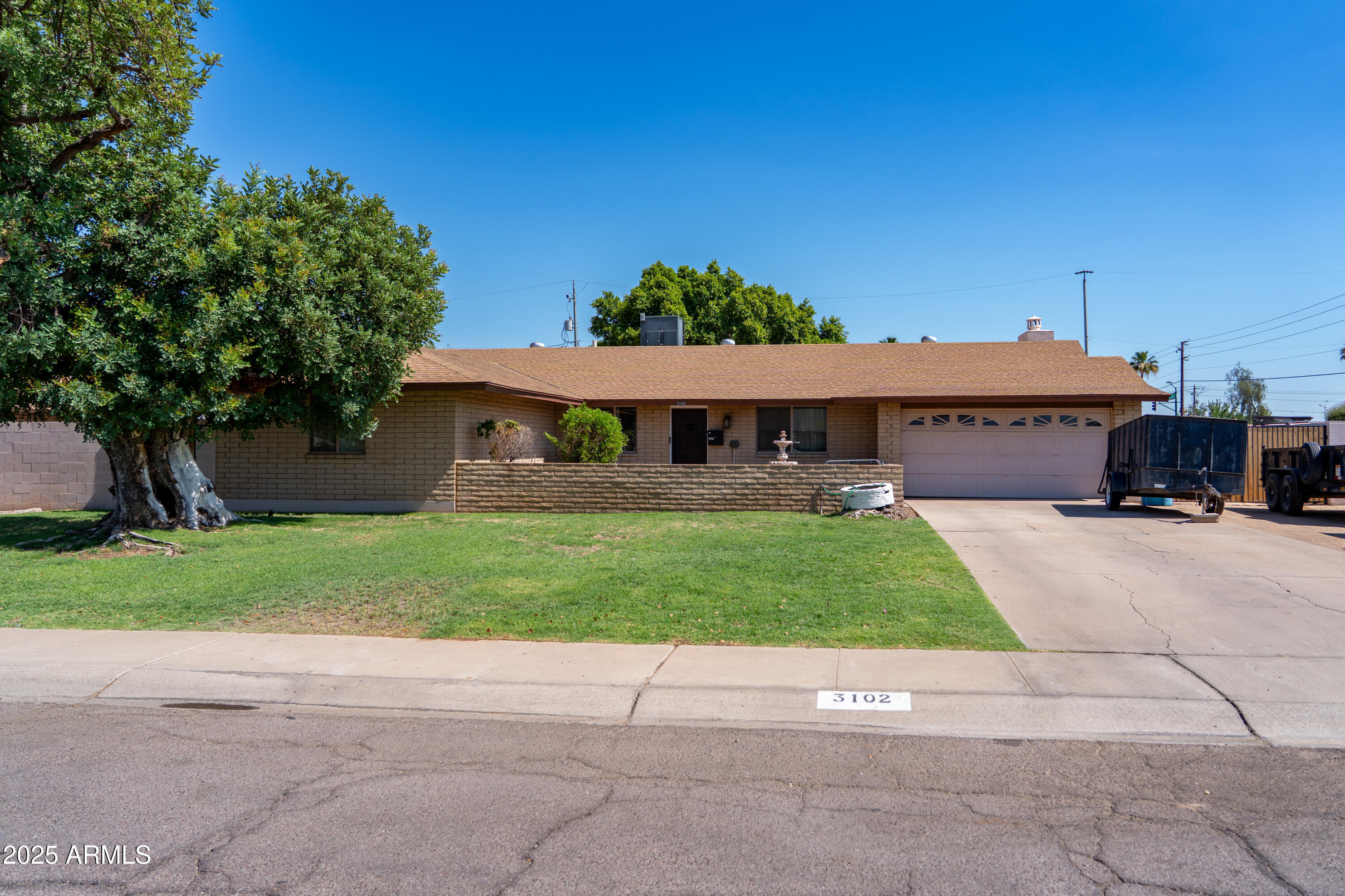 3102 West Paradise Drive Phoenix, AZ 85029 - Photo 1 of 22 a front view of a house with a yard and garage
