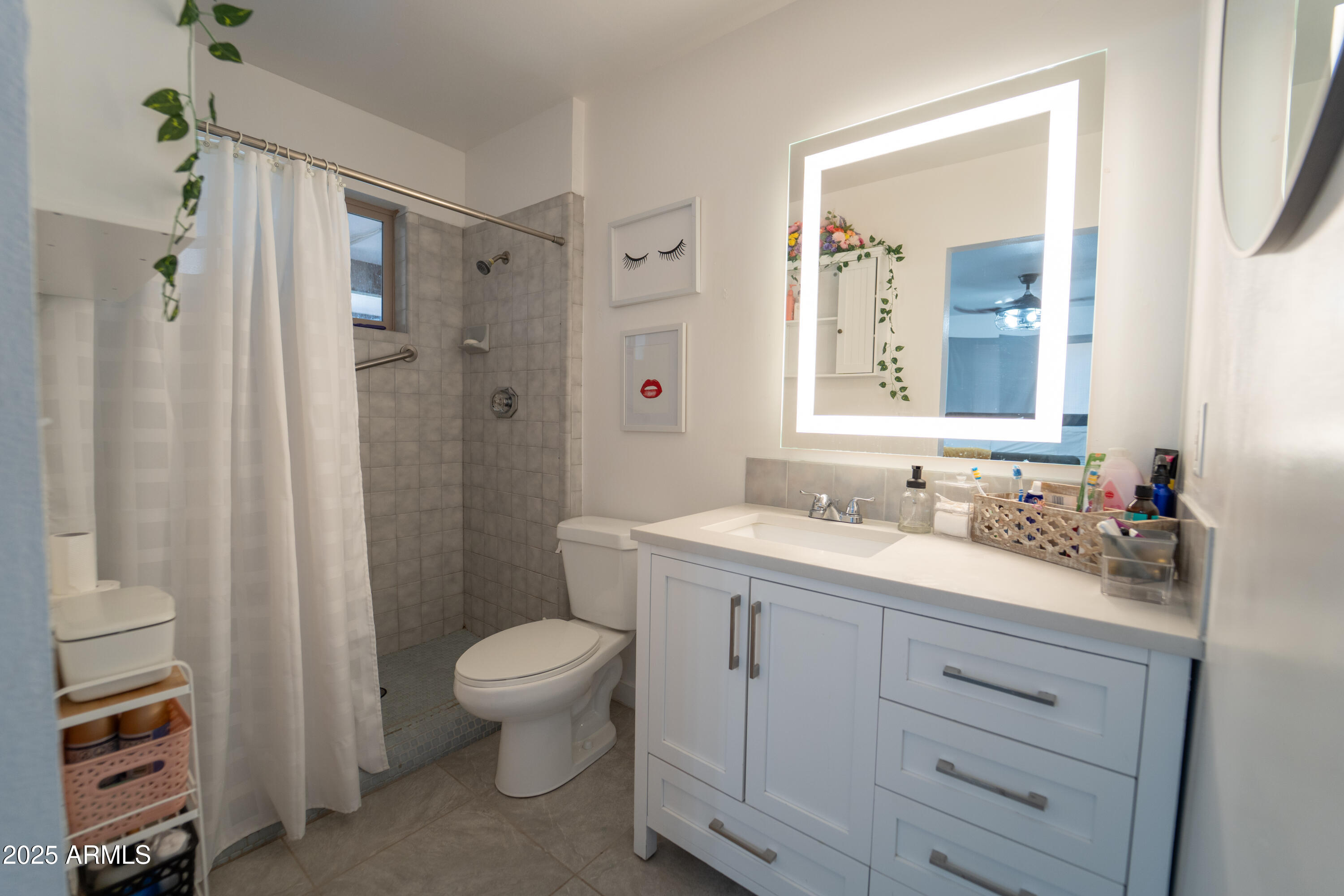 3102 West Paradise Drive Phoenix, AZ 85029 - Photo 13 of 22 a bathroom with a granite countertop sink toilet a mirror a vanity and shower