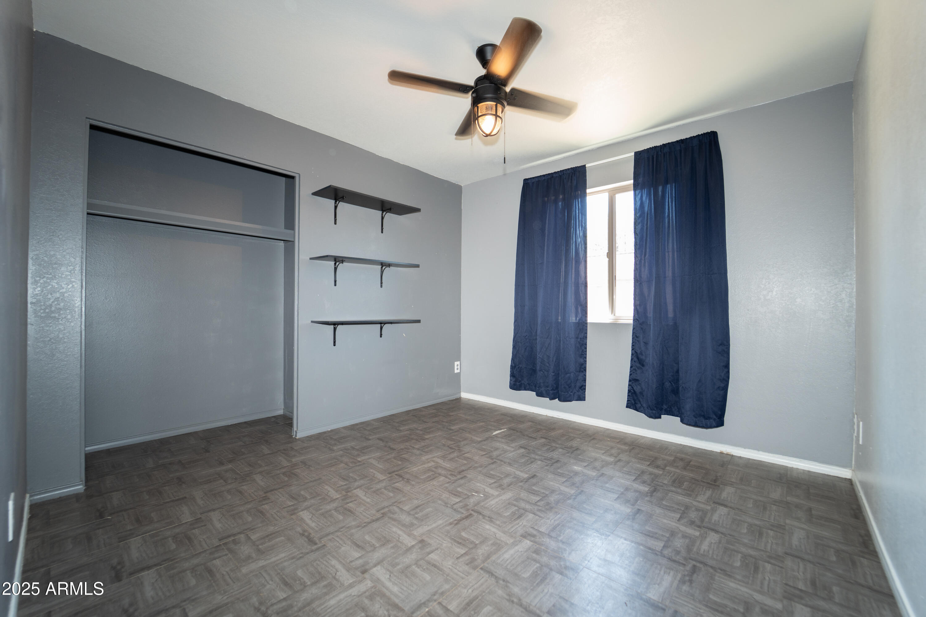 3102 West Paradise Drive Phoenix, AZ 85029 - Photo 14 of 22 a view of empty room with a ceiling fan