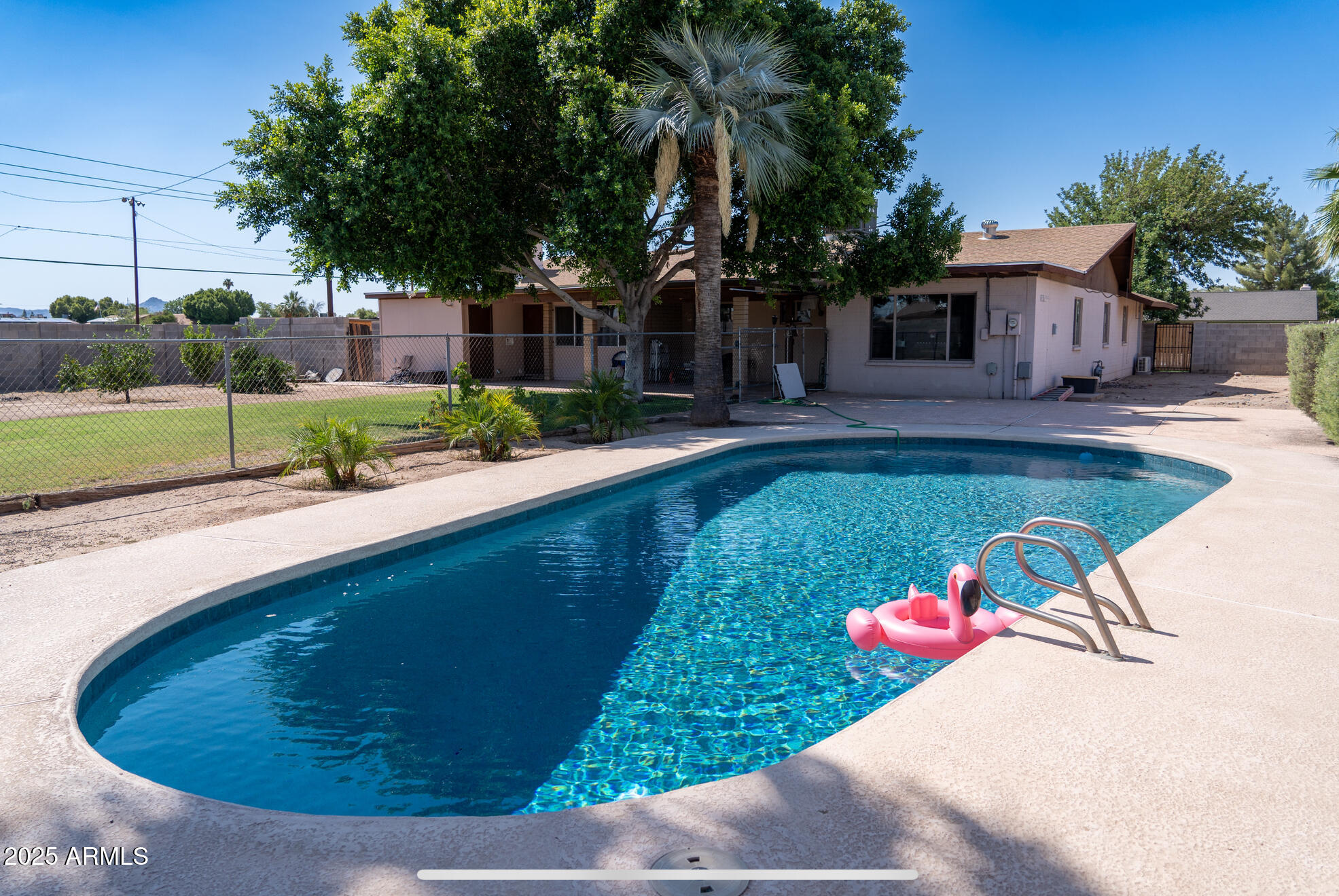 3102 West Paradise Drive Phoenix, AZ 85029 - Photo 20 of 22 a view of a house with swimming pool and a yard