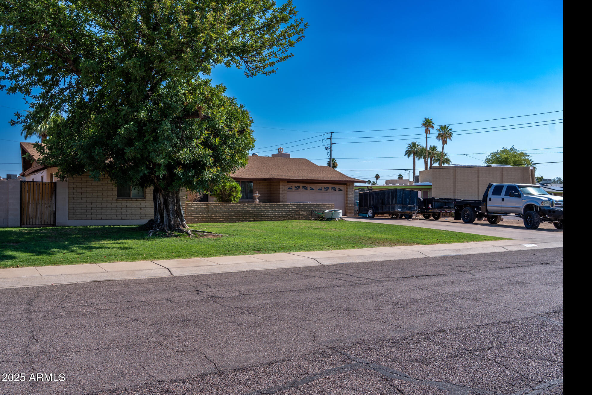 3102 West Paradise Drive Phoenix, AZ 85029 - Photo 2 of 22 a view of a house with a big yard and large trees