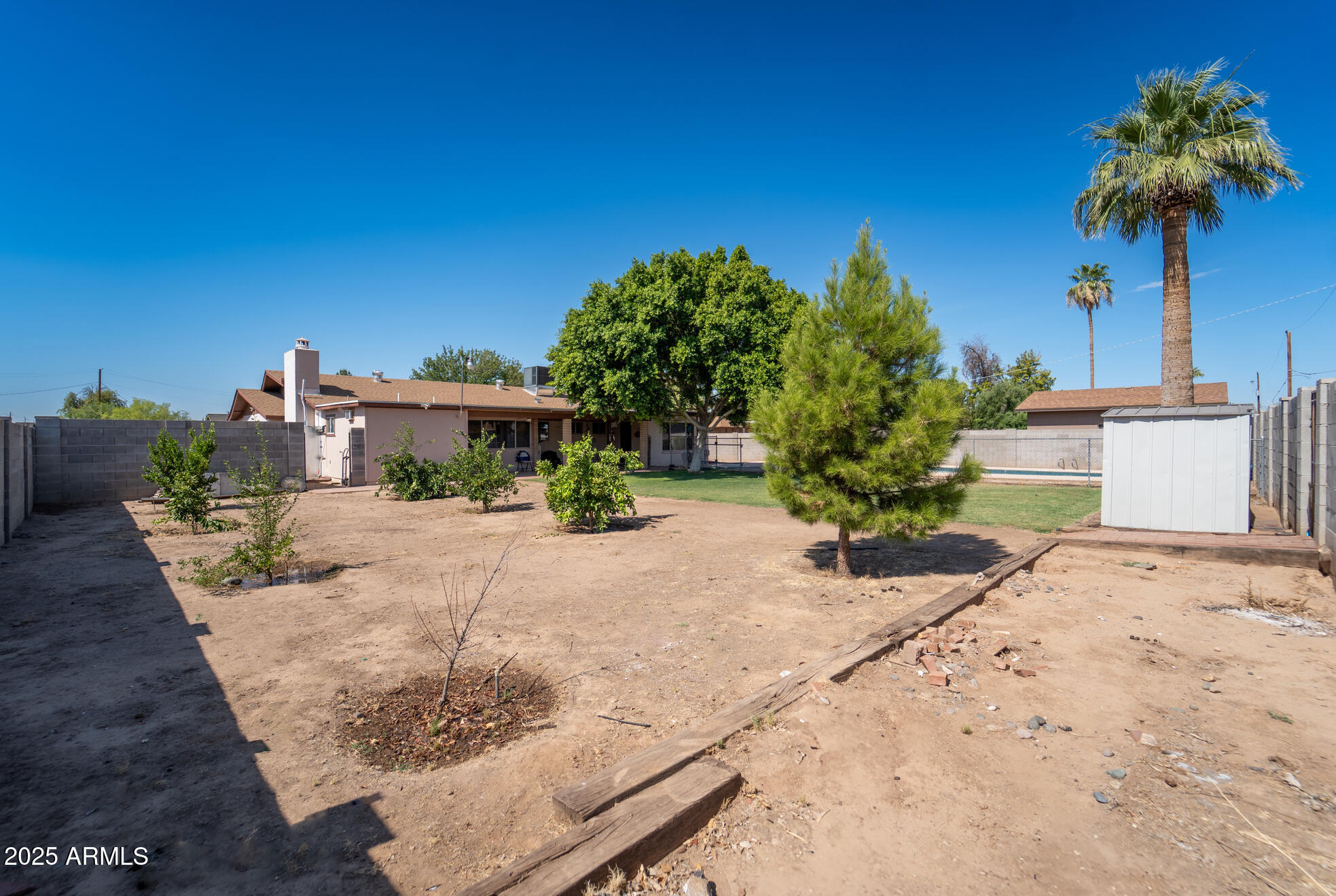 3102 West Paradise Drive Phoenix, AZ 85029 - Photo 21 of 22 a front view of a house with a yard and garage