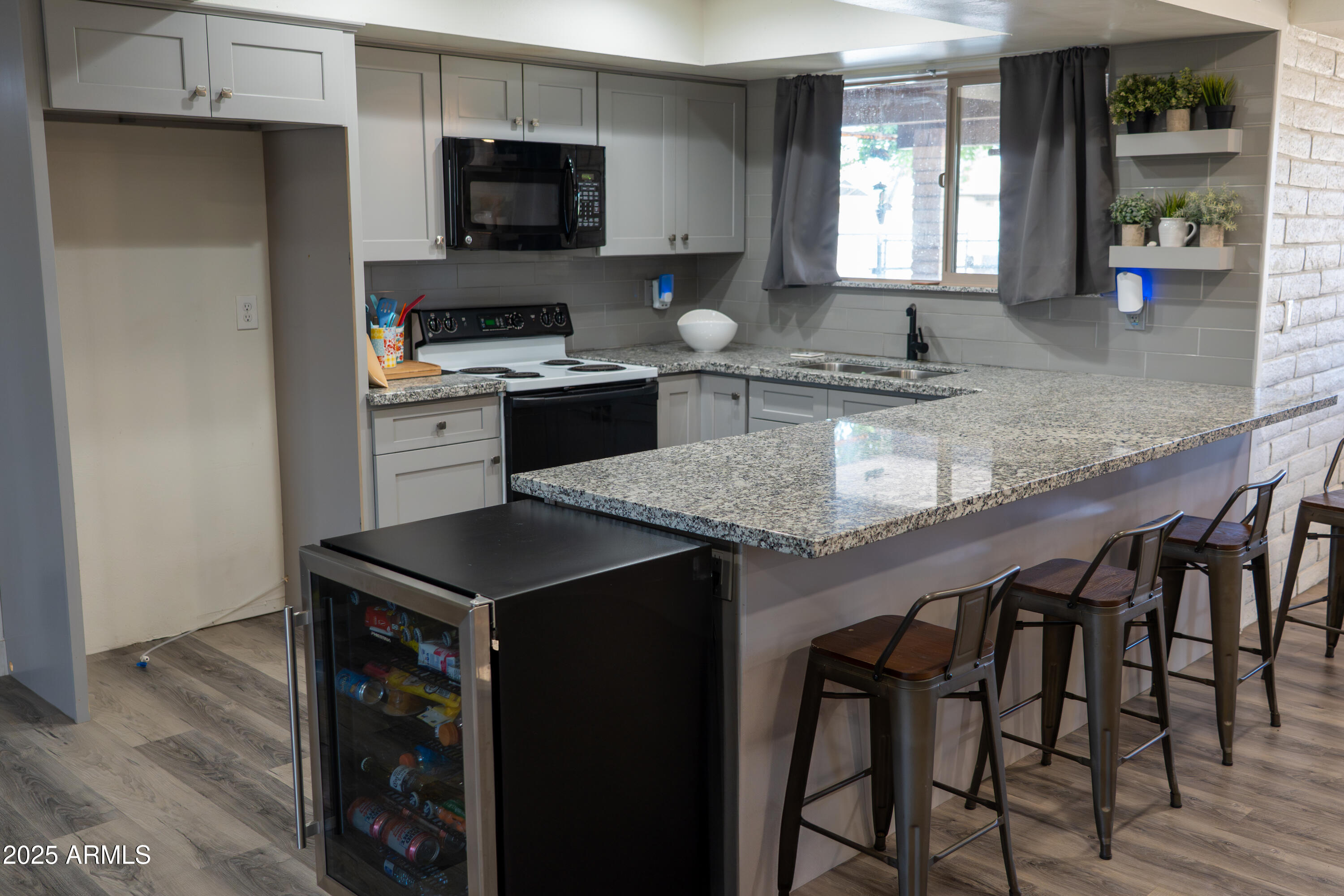 3102 West Paradise Drive Phoenix, AZ 85029 - Photo 6 of 22 a kitchen with granite countertop stainless steel appliances a sink cabinets and a window