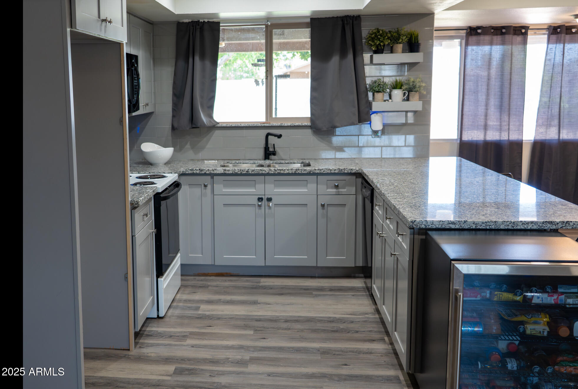 3102 West Paradise Drive Phoenix, AZ 85029 - Photo 7 of 22 a kitchen with granite countertop a sink and a stove
